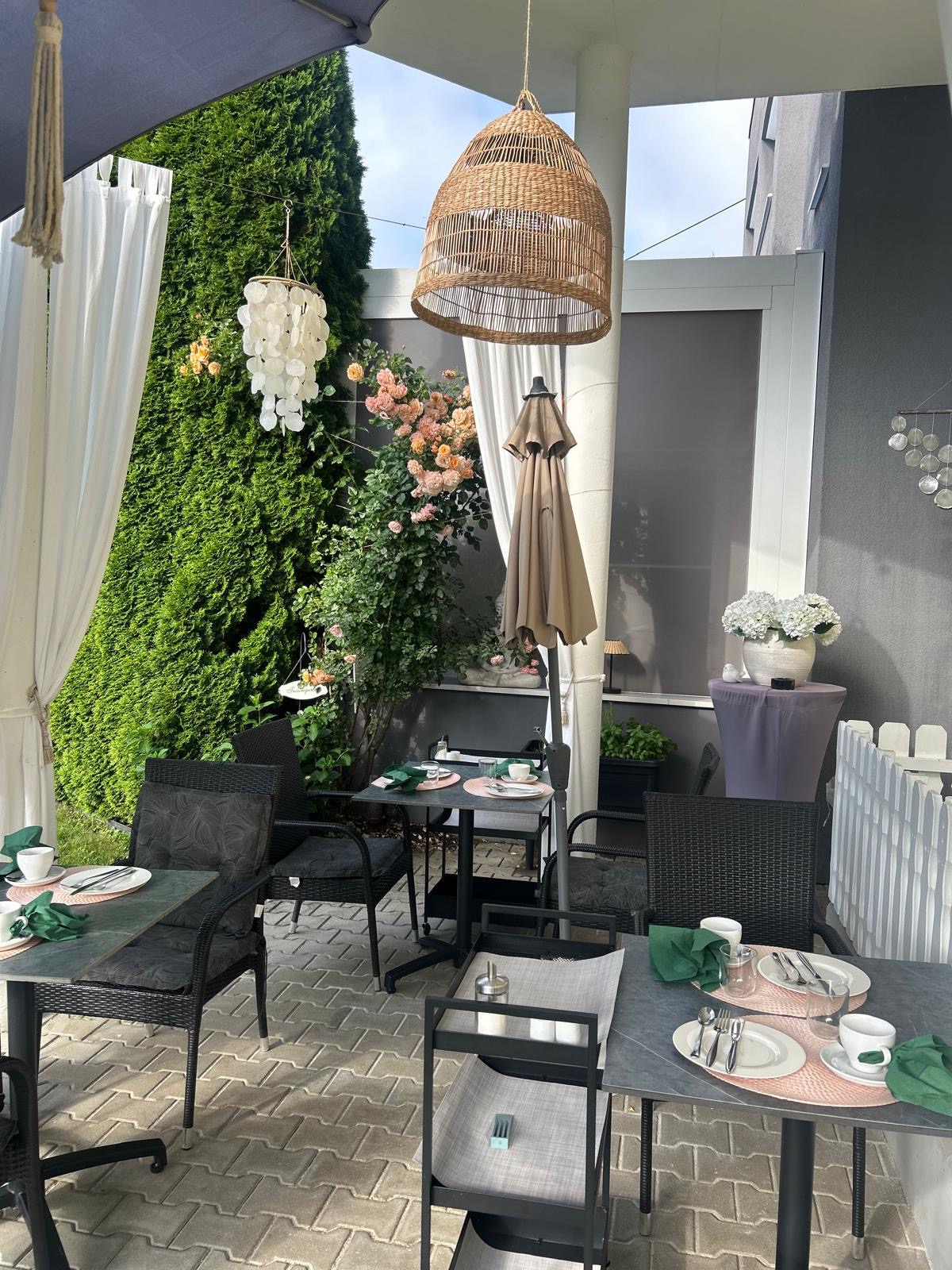 Gedeckte Frühstückstische auf der Terrasse